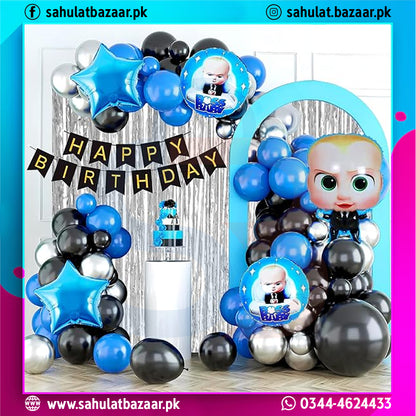 Birthday party decorations with balloons, arch, and 'Happy Birthday' banner.