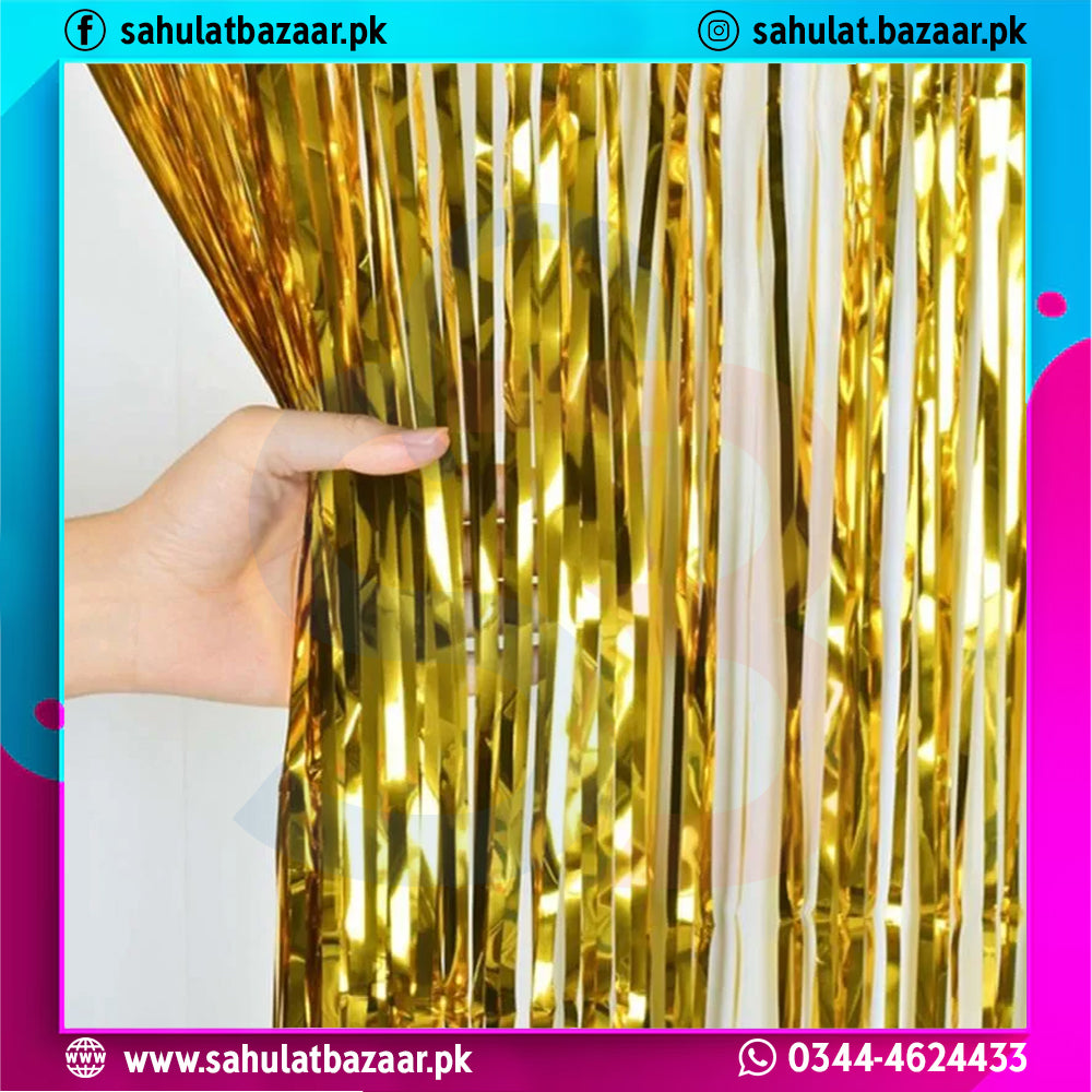Gold tinsel curtain held by a hand with colorful border and contact information.
