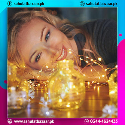 Woman lying on a wooden floor with string lights and decorative balls, surrounded by colorful text and logos.