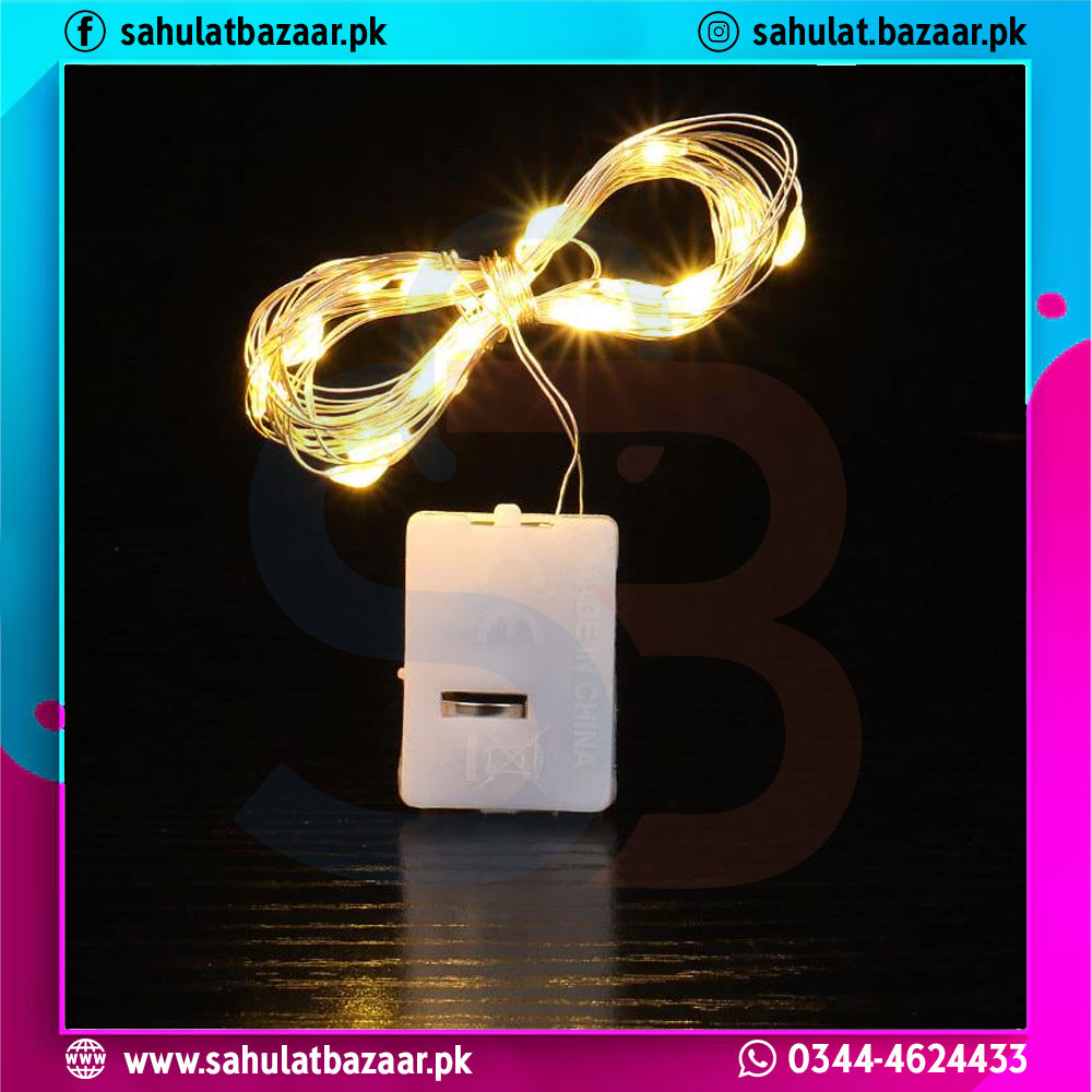 Small white device with glowing yellow string lights on a dark background, branded 'sahulatbazaar.pk'.