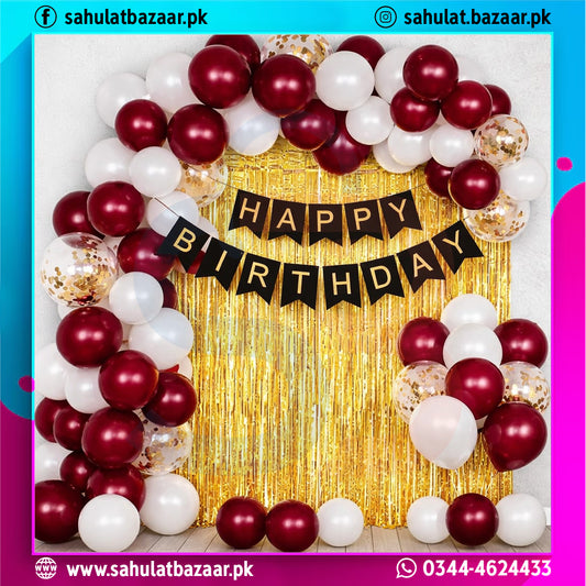 Birthday balloon arch with 'Happy Birthday' banner against a gold curtain, featuring red, white, and gold balloons.
