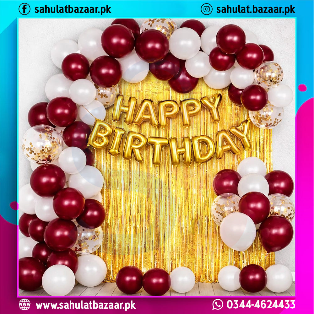 Birthday decoration with balloons and 'Happy Birthday' banner on a gold curtain.