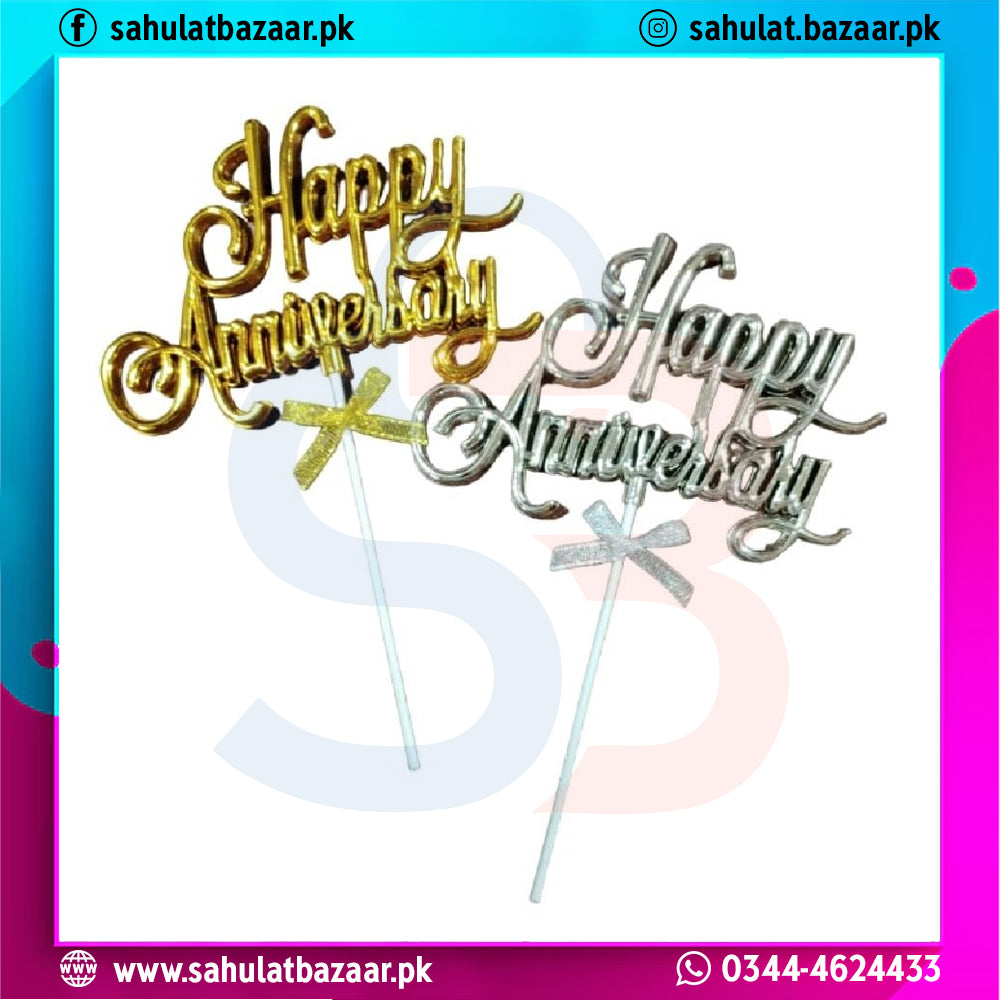 Two 'Happy Anniversary' cake toppers on sticks with gold and silver text against a colorful border.