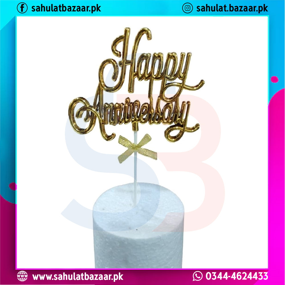 Gold 'Happy Anniversary' candle topper on a white candle against a colorful border with branding text.