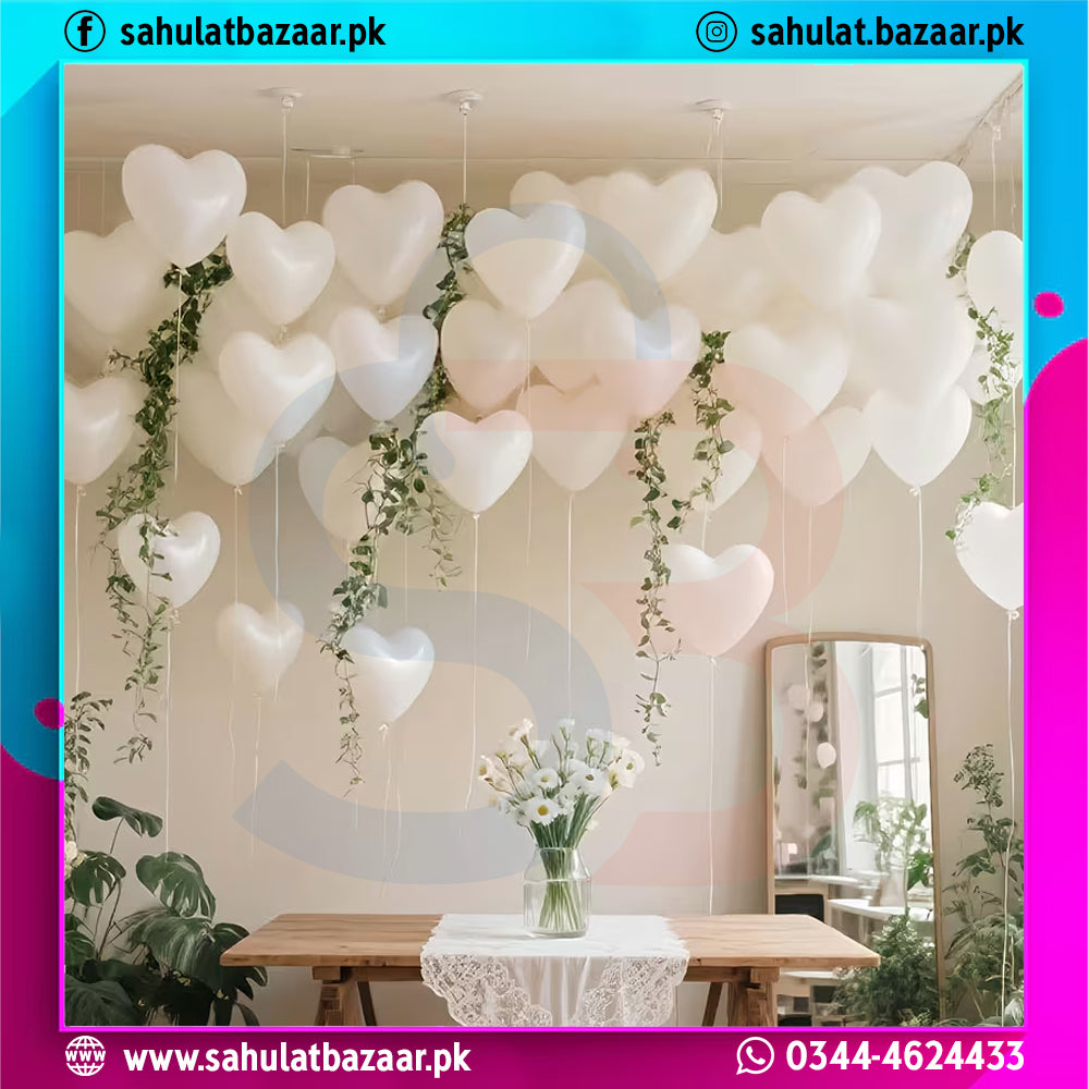 Decorative setup with heart-shaped balloons and floral arrangements in a room.