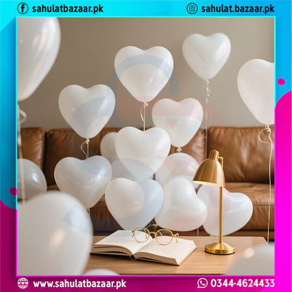Heart-shaped balloons in a room with a brown couch and a lamp.