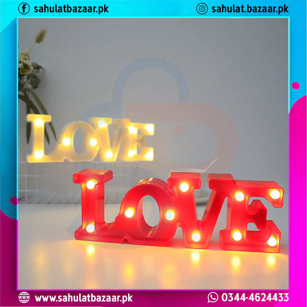Red 'LOVE' light-up sign with a blurred background