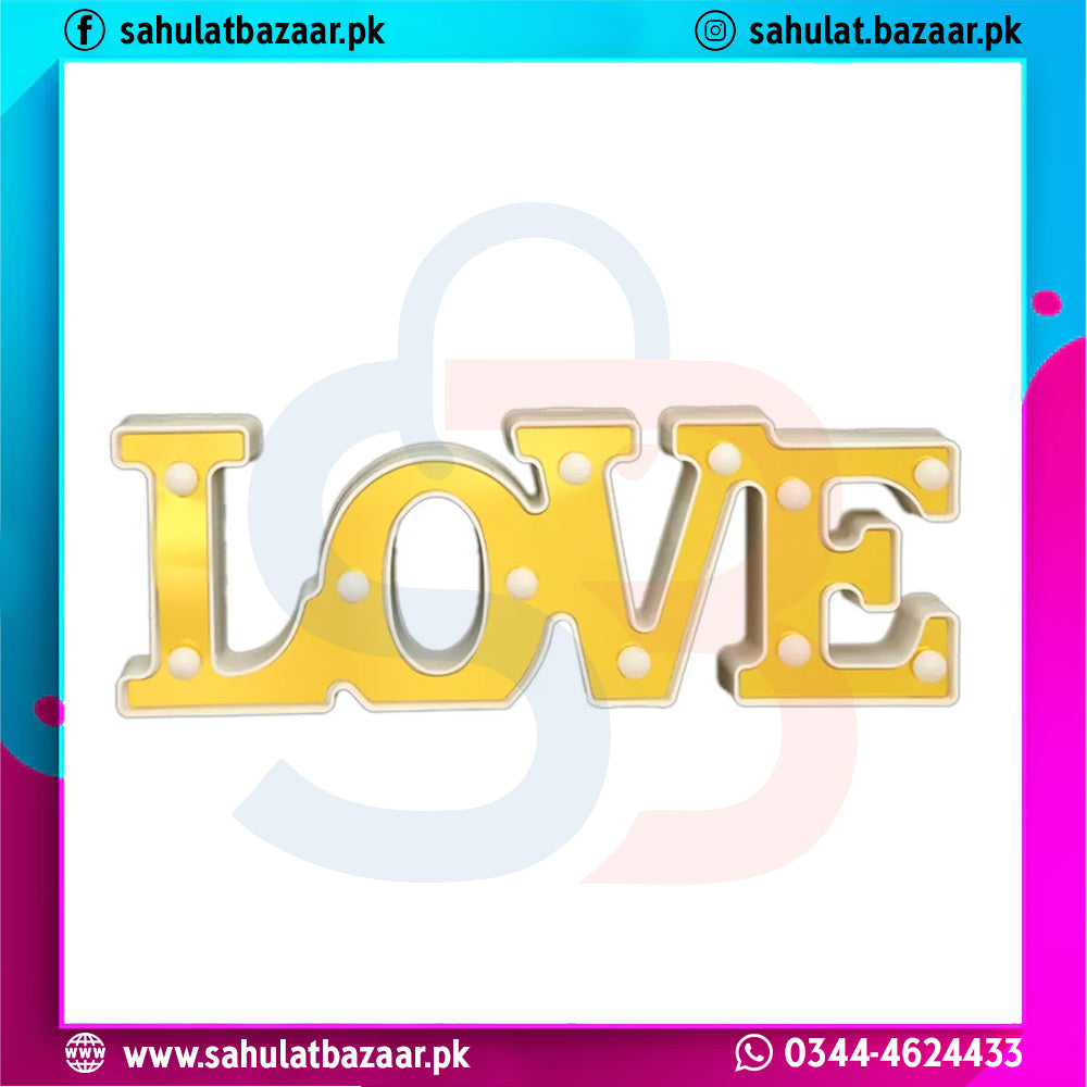 Decorative sign with 'LOVE' in gold letters on a white background