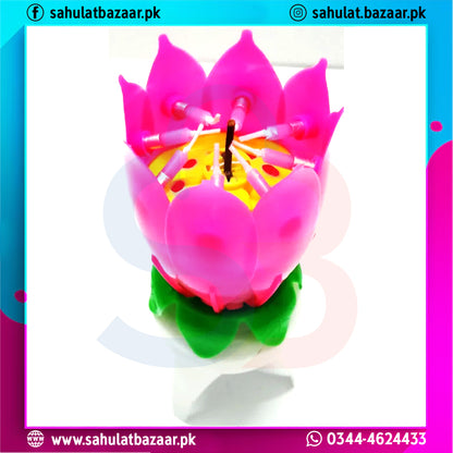 Pink lotus-shaped candle with a green base on a white background, branded 'sahulatbazaar.pk'.