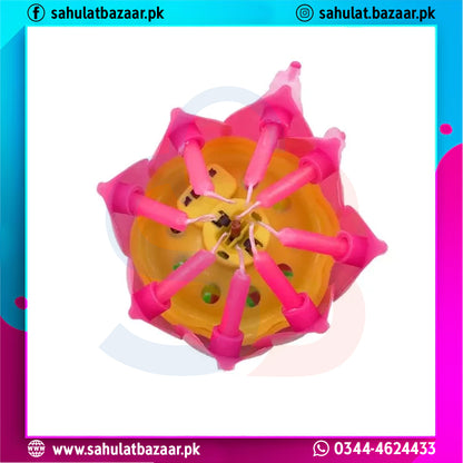 Pink and yellow plastic tool with multiple prongs on a white background