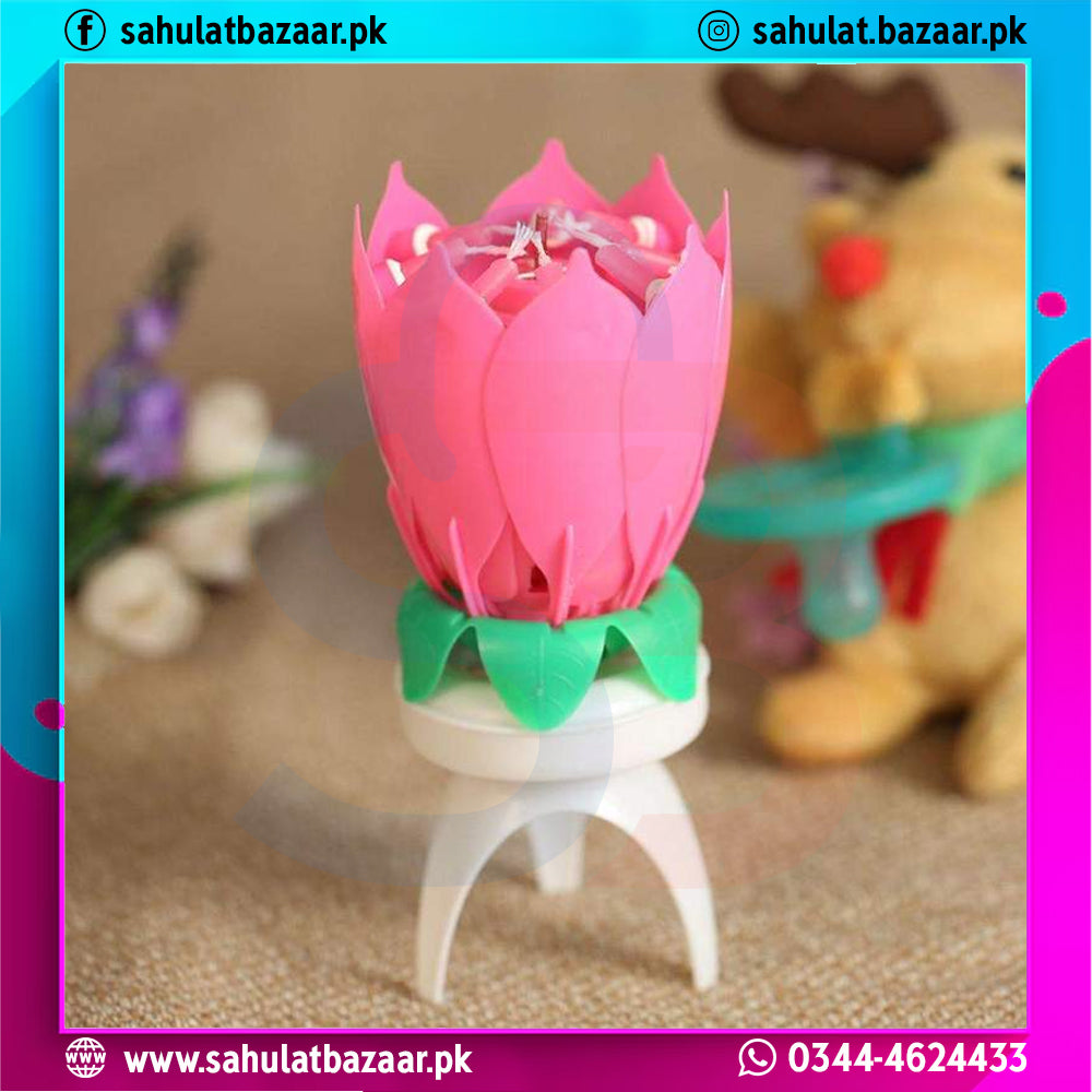 Pink lotus-shaped candle with a white base on a blurred background