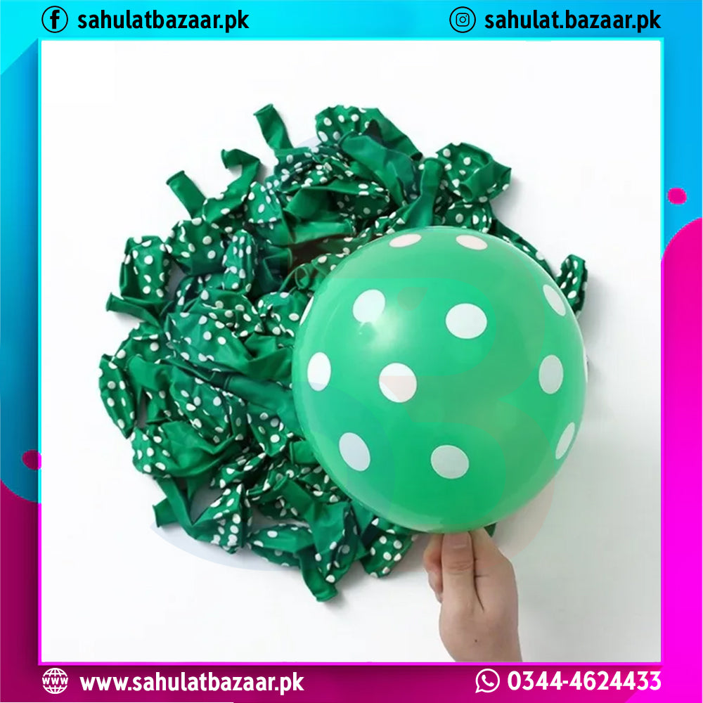 Green balloon with white polka dots held by a hand against a white background, with decorative ribbons.