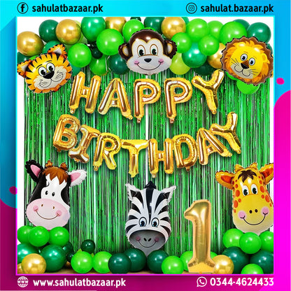 Birthday decoration with animal-themed balloons and 'Happy Birthday' text against a green curtain.